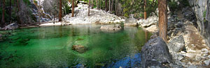 The water assumes the emerald color of the mineral-laden stream bed