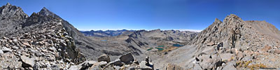 A 280 degree south(L) to north(R) view into Kings Canyon Nat'l. Park from the ridge of 12,700ft. Jigsaw Pass. Aperture Pk (near L) & Mt. Agassiz (distant L) above Jigsaw Pass (notch between the two), Dusy Basin (distant L of ctr.), Bishop Pass, (ctr.), Bishop & Saddlerock lakes, Picture Puzzle Pk. (2nd from R.)